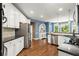 Well-lit kitchen features stainless steel appliances, granite countertops, and breakfast nook in background at 580 Washington Way, Cumming, GA 30040
