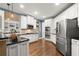 Modern kitchen features stainless steel appliances, granite countertops and ample white cabinetry at 580 Washington Way, Cumming, GA 30040