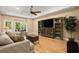 The inviting living room features a ceiling fan, hardwood floors, and exterior access at 580 Washington Way, Cumming, GA 30040