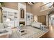 Bright living room featuring a fireplace, built-ins, and hardwood flooring at 580 Washington Way, Cumming, GA 30040