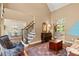 Spacious living area with hardwood floors, staircase, and elegant furniture at 580 Washington Way, Cumming, GA 30040