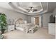 A bright main bedroom with a tray ceiling, a king bed, and neutral color pallette at 580 Washington Way, Cumming, GA 30040