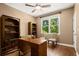 Bright home office with hardwood floors, a ceiling fan, a window, and a desk at 580 Washington Way, Cumming, GA 30040