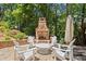 The backyard features a lovely stone patio with comfortable seating and an outdoor fireplace, perfect for entertaining at 580 Washington Way, Cumming, GA 30040