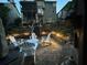 Relaxing outdoor patio with seating, ambient lighting, and a cozy atmosphere for entertaining in the backyard at 580 Washington Way, Cumming, GA 30040