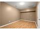 A finished room with a neutral color palette and hardwood floors at 580 Washington Way, Cumming, GA 30040