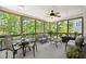 Inviting screened-in porch features a ceiling fan, and plenty of comfortable seating with views of the backyard at 580 Washington Way, Cumming, GA 30040