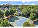 Overhead shot of well-maintained tennis and basketball courts within a green residential community with mature trees at 580 Washington Way, Cumming, GA 30040
