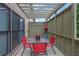 Outdoor back deck including table, chairs, privacy lattice, and ceiling trellis at 10765 Arlington Pt, Alpharetta, GA 30022