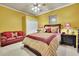 Bright bedroom featuring queen size bed, side tables, and a plush leather sofa at 10765 Arlington Pt, Alpharetta, GA 30022