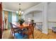 Elegant dining room with hardwood floors, chandelier, and decorative archway at 10765 Arlington Pt, Alpharetta, GA 30022