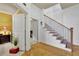 Elegant entryway with hardwood floors, white wainscoting, and a staircase with wood and iron railings at 10765 Arlington Pt, Alpharetta, GA 30022