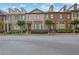 Beautiful row of brick townhomes featuring manicured lawns and inviting curb appeal at 10765 Arlington Pt, Alpharetta, GA 30022