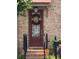 Inviting entrance with a decorative wreath and a well-lit porch at 10765 Arlington Pt, Alpharetta, GA 30022