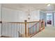 Well-lit hallway with decorative molding and access to multiple rooms at 10765 Arlington Pt, Alpharetta, GA 30022
