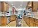 Spacious kitchen features granite countertops, wood cabinets, stainless steel appliances, and a central island at 10765 Arlington Pt, Alpharetta, GA 30022