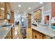 Open kitchen features wood cabinets, granite countertops, stainless appliances, and a breakfast bar at 10765 Arlington Pt, Alpharetta, GA 30022