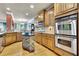 Gourmet kitchen boasts stainless steel appliances, custom wood cabinetry, and stylish central island at 10765 Arlington Pt, Alpharetta, GA 30022