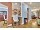 Bright kitchen featuring wood cabinets, granite countertops, and a breakfast bar with seating at 10765 Arlington Pt, Alpharetta, GA 30022