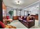 Bright living room featuring a leather sofa, wooden dresser, decorative cabinet, and views to the main bedroom at 10765 Arlington Pt, Alpharetta, GA 30022