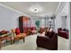 Inviting living room with comfortable seating, including a plush leather sofa, and decorative wooden cabinet at 10765 Arlington Pt, Alpharetta, GA 30022