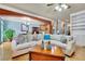 Open-concept living space featuring a comfortable sectional sofa and hardwood floors at 10765 Arlington Pt, Alpharetta, GA 30022