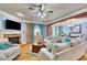 Cozy living room features hardwood floors, a fireplace, and comfortable seating, with lots of natural light at 10765 Arlington Pt, Alpharetta, GA 30022