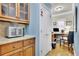 Pantry with wood cabinets, countertop, and small office space at 10765 Arlington Pt, Alpharetta, GA 30022