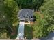 An aerial view of a beautiful home with a large driveway and lush landscaping at 3915 Ashley Trace Sw Ct, Lilburn, GA 30047
