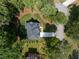 Aerial view of a home with a dark roof and surrounded by mature trees at 3915 Ashley Trace Sw Ct, Lilburn, GA 30047