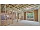 Unfinished basement with exposed framing, insulation, and a window at 3915 Ashley Trace Sw Ct, Lilburn, GA 30047