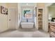 Modern bathroom with a freestanding tub, picture window, and custom storage at 3915 Ashley Trace Sw Ct, Lilburn, GA 30047