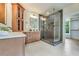 Bathroom with custom wood cabinets, double sinks, and a glass enclosed shower at 3915 Ashley Trace Sw Ct, Lilburn, GA 30047