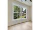 Bright bedroom showcasing a large window offering views of a lush green neighborhood at 3915 Ashley Trace Sw Ct, Lilburn, GA 30047