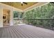Covered deck with wooden ceiling, iron railings, and a view of the surrounding woods at 3915 Ashley Trace Sw Ct, Lilburn, GA 30047