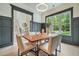 Cozy dining room features wainscoting, modern chandelier, and an open layout at 3915 Ashley Trace Sw Ct, Lilburn, GA 30047