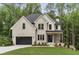 Charming two-story home featuring a brick facade, black accents, and a manicured front lawn at 3915 Ashley Trace Sw Ct, Lilburn, GA 30047