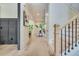 Elegant foyer featuring hardwood floors, paneled walls, and an open staircase at 3915 Ashley Trace Sw Ct, Lilburn, GA 30047