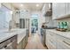 Bright kitchen features white cabinets, stainless steel appliances, and a view into the dining room at 3915 Ashley Trace Sw Ct, Lilburn, GA 30047
