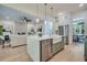 Open concept kitchen with stainless appliances, island with sink, and adjoined living room at 3915 Ashley Trace Sw Ct, Lilburn, GA 30047