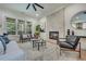 Bright living room with fireplace, ceiling fan, and view of the outdoor deck at 3915 Ashley Trace Sw Ct, Lilburn, GA 30047