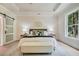 Spacious main bedroom features hardwood floors, a ceiling fan, and large windows at 3915 Ashley Trace Sw Ct, Lilburn, GA 30047