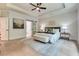 Spacious main bedroom features hardwood floors, a ceiling fan, and large windows at 3915 Ashley Trace Sw Ct, Lilburn, GA 30047