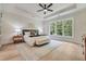 Spacious main bedroom features hardwood floors, a ceiling fan, and large windows at 3915 Ashley Trace Sw Ct, Lilburn, GA 30047