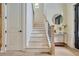 View of the staircase with hardwood steps, a black metal banister, and stylish decor at 3915 Ashley Trace Sw Ct, Lilburn, GA 30047