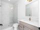 Bright bathroom featuring a glass shower and designer vanity with gold fixtures at 415 Mayfair Ct, Alpharetta, GA 30009