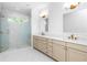 Elegant bathroom with glass shower, dual vanity and modern gold fixtures at 415 Mayfair Ct, Alpharetta, GA 30009