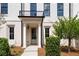 Close up of front door entrance with classic trim, complemented by manicured landscaping at 415 Mayfair Ct, Alpharetta, GA 30009