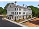Stunning exterior view of townhome with balconies, brick facade, and professionally landscaped grounds at 415 Mayfair Ct, Alpharetta, GA 30009