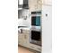 Close up of Kitchenaid double oven with tiled backsplash and shaker cabinets at 415 Mayfair Ct, Alpharetta, GA 30009